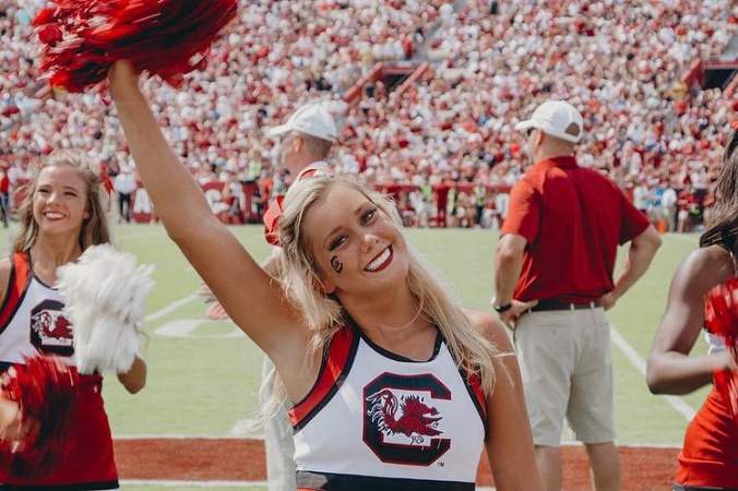 Sidney Tilton cheerleading for her university's team. 